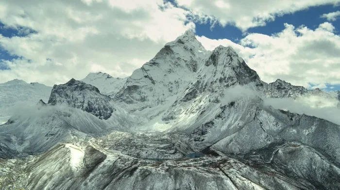 Snow Covered Mountain Range Under Cloudy Sky wallpapers
