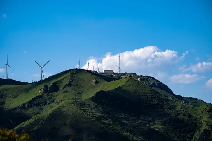 Wind Turbines On Lush Green Hill wallpapers