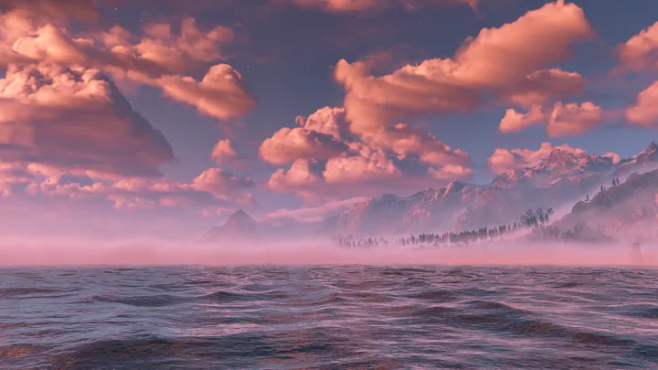 A beautiful sunset over the ocean with mountains in the background