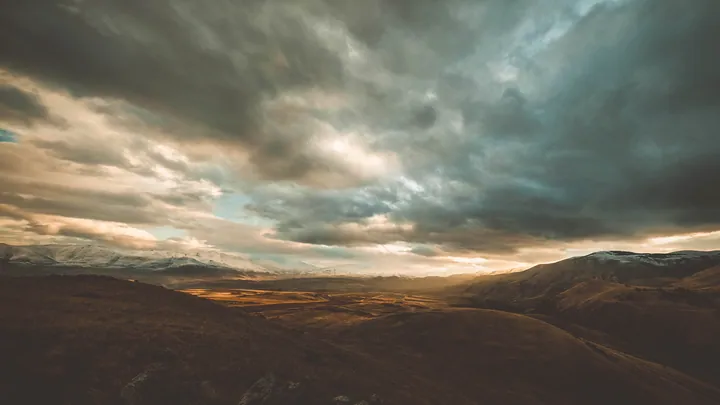 Mountain Range Sunset Silhouette Against Cloudy Sky wallpapers
