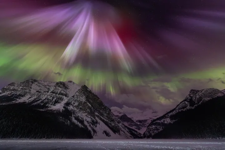 Aurora Borealis Over Snow-Capped Lake Louise Peaks wallpapers