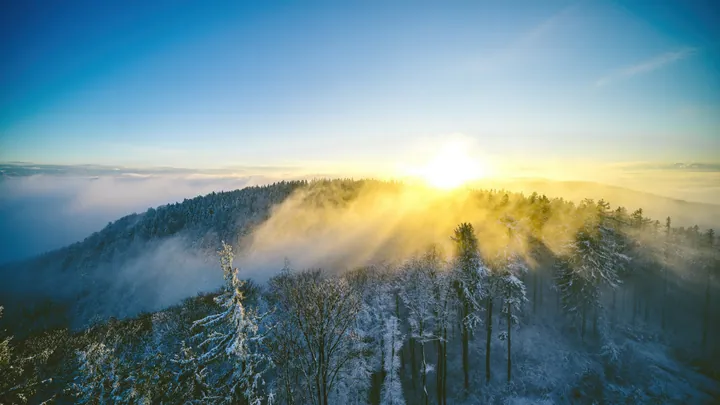 Snowy Mountain Landscape With Sunlight Through Clouds wallpapers