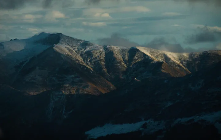 Snowy Caucasus Mountains Under Cloudy Sky — original wallpaper
