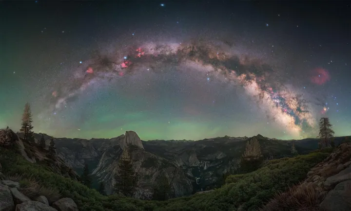 A breathtaking view of the Milky Way stretching across the night sky above Half Dome in Yosemite National Park, California