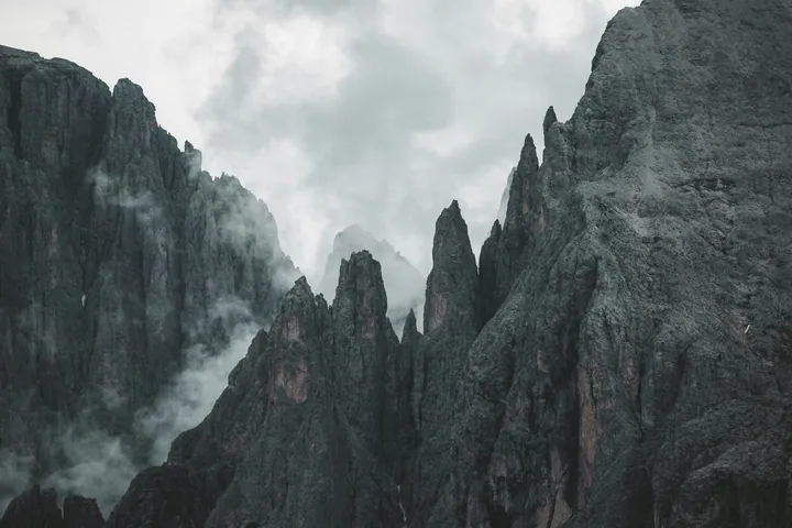 Fog-Covered Mountain Range Under Cloudy Sky — original wallpaper