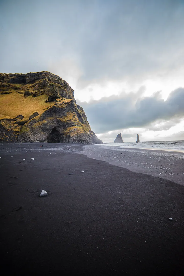 Black Sand Beach With Large Rock Formation — original wallpaper