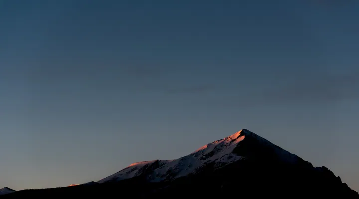 Snowy Mountain Peak Against Blue Sky — original wallpaper