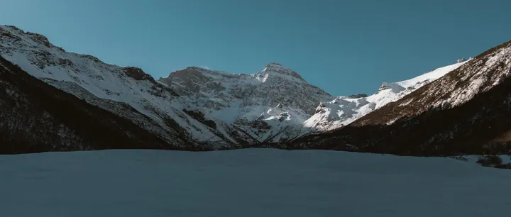 Snowy Mountain Range Over Still Lake wallpapers