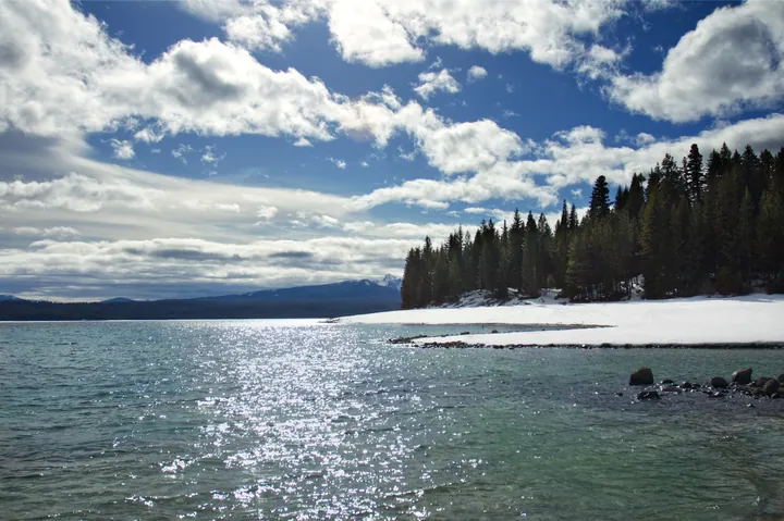 Snow-Covered Mountains Surrounding Lake Shore wallpapers