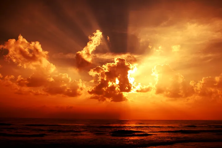 Sunset Over Calm Ocean With Glowing Clouds wallpapers