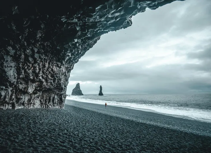 Lonely Figure On Black Sand Beach wallpapers