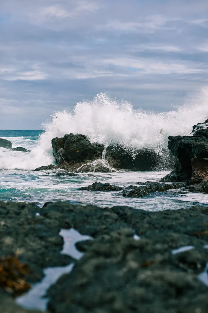 Spray Waves Crashing On Dark Shore Rocks wallpapers