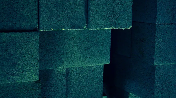 Stacked Green Cinder Blocks Forming Wall wallpapers
