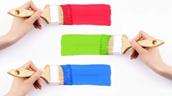 Hands Holding Paintbrushes With Colorful Paint wallpapers